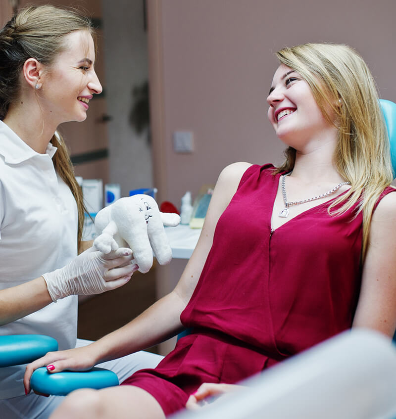 clinton township woman discussing tmj headache relief treatments with shelby township tmj dentist