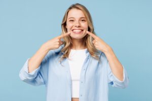 woman shows off her bright smile after teeth whitening from Shelby Township dentist
