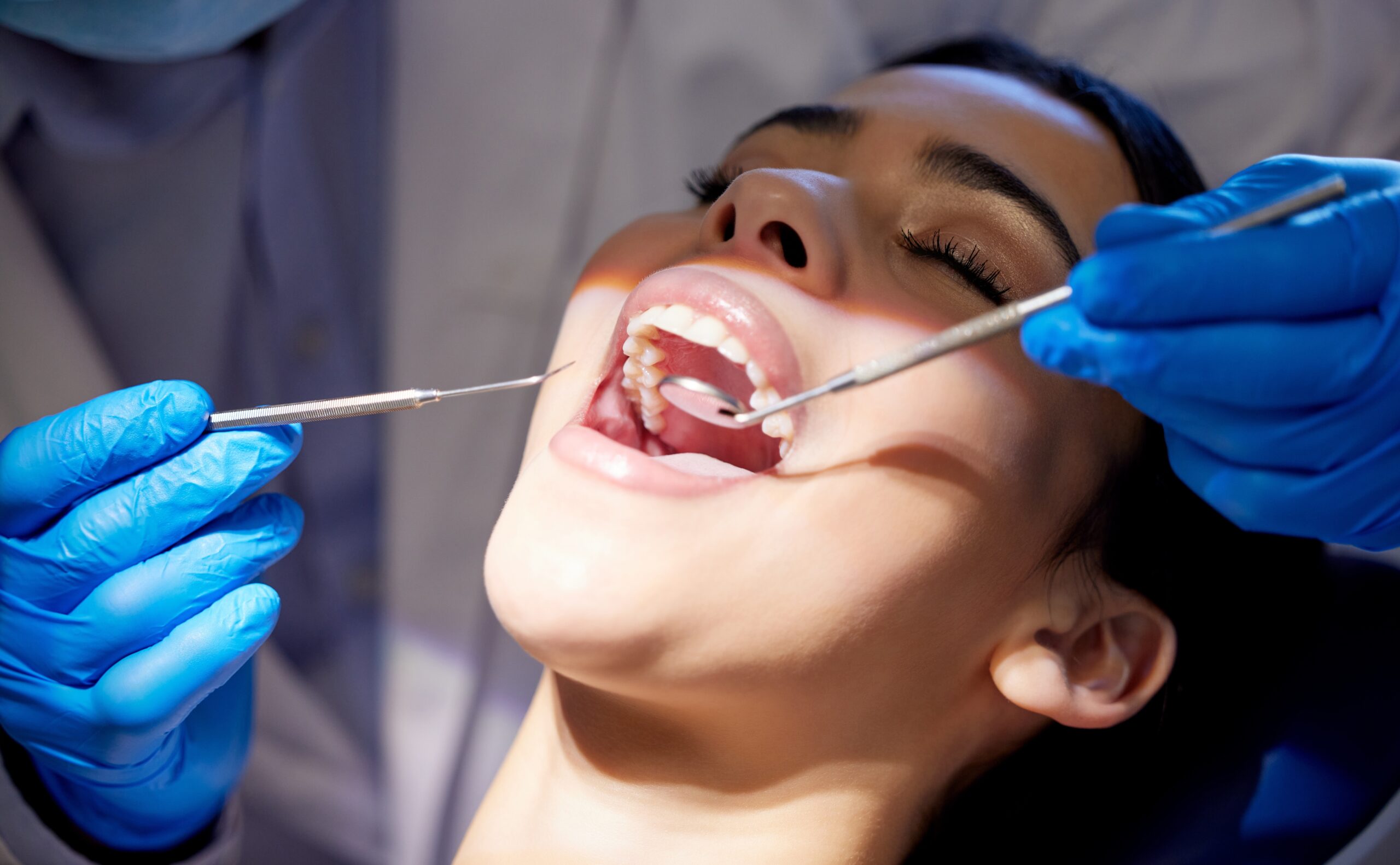 doctor examining a patients mouth before placing a same-day crown