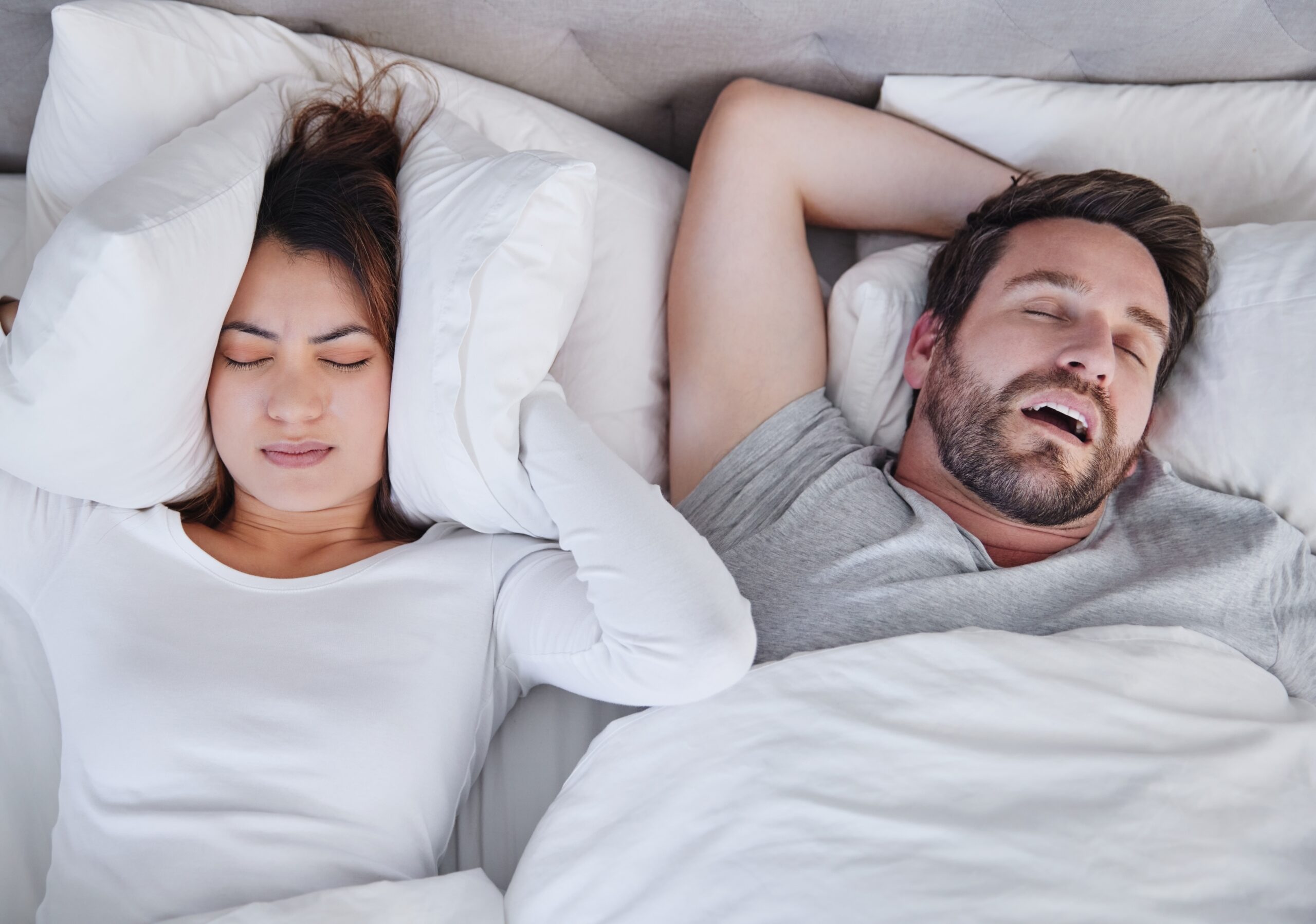 man snoring and disrupting his partner