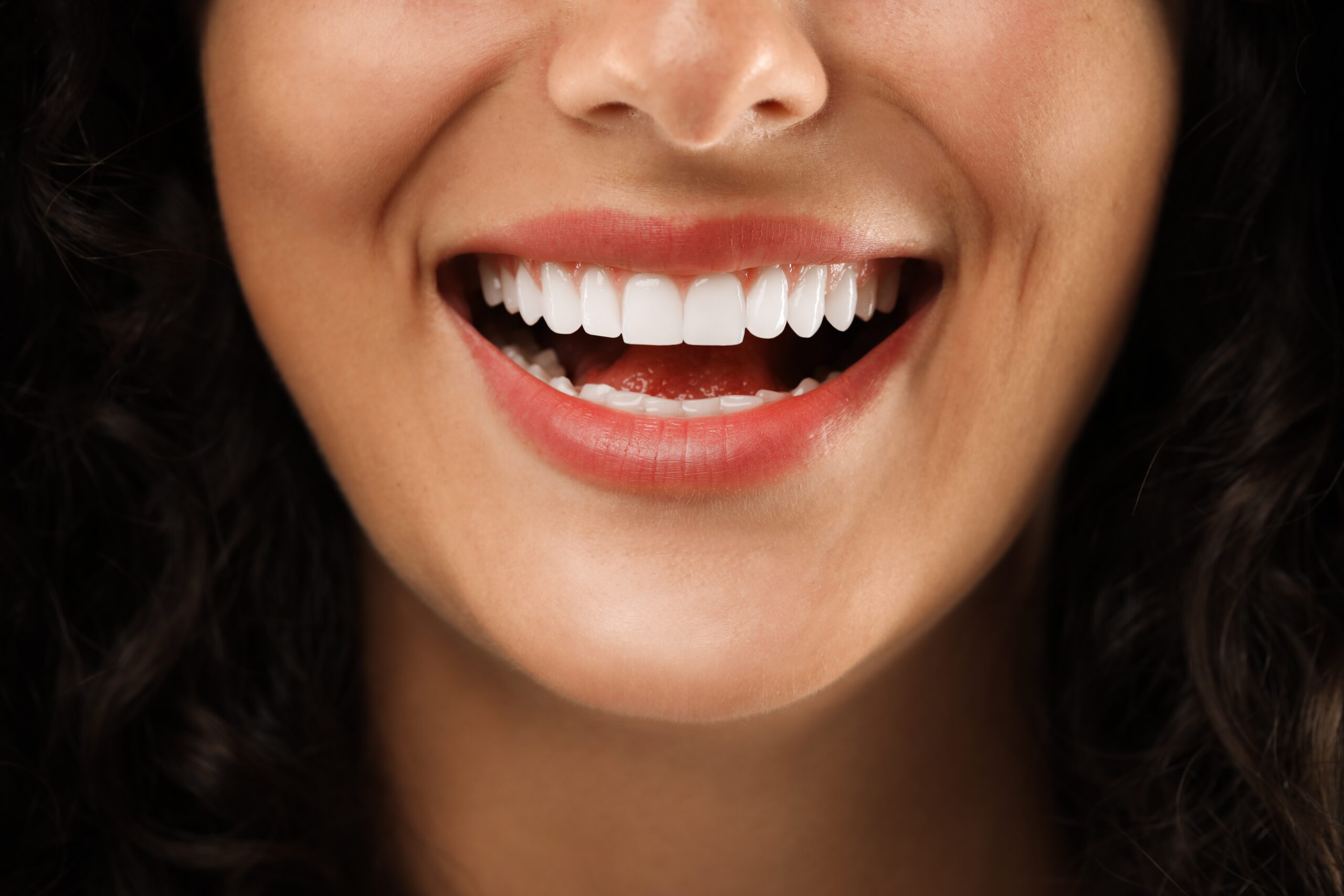 closeup of a woman flashing her flawless smile