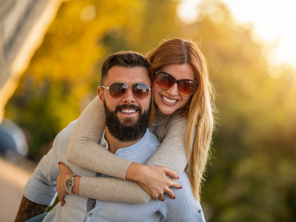 clinton township couple smiling after teeth whitening at shelby township dentist