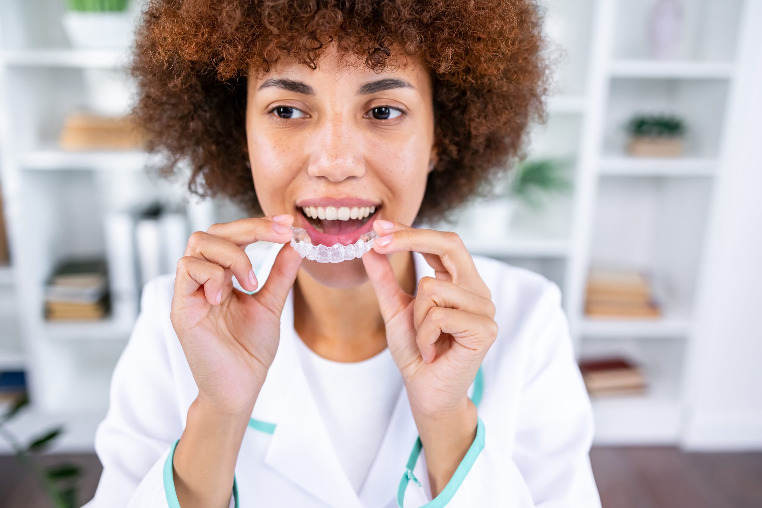 Joyful young woman undergoing clear aligner treatment