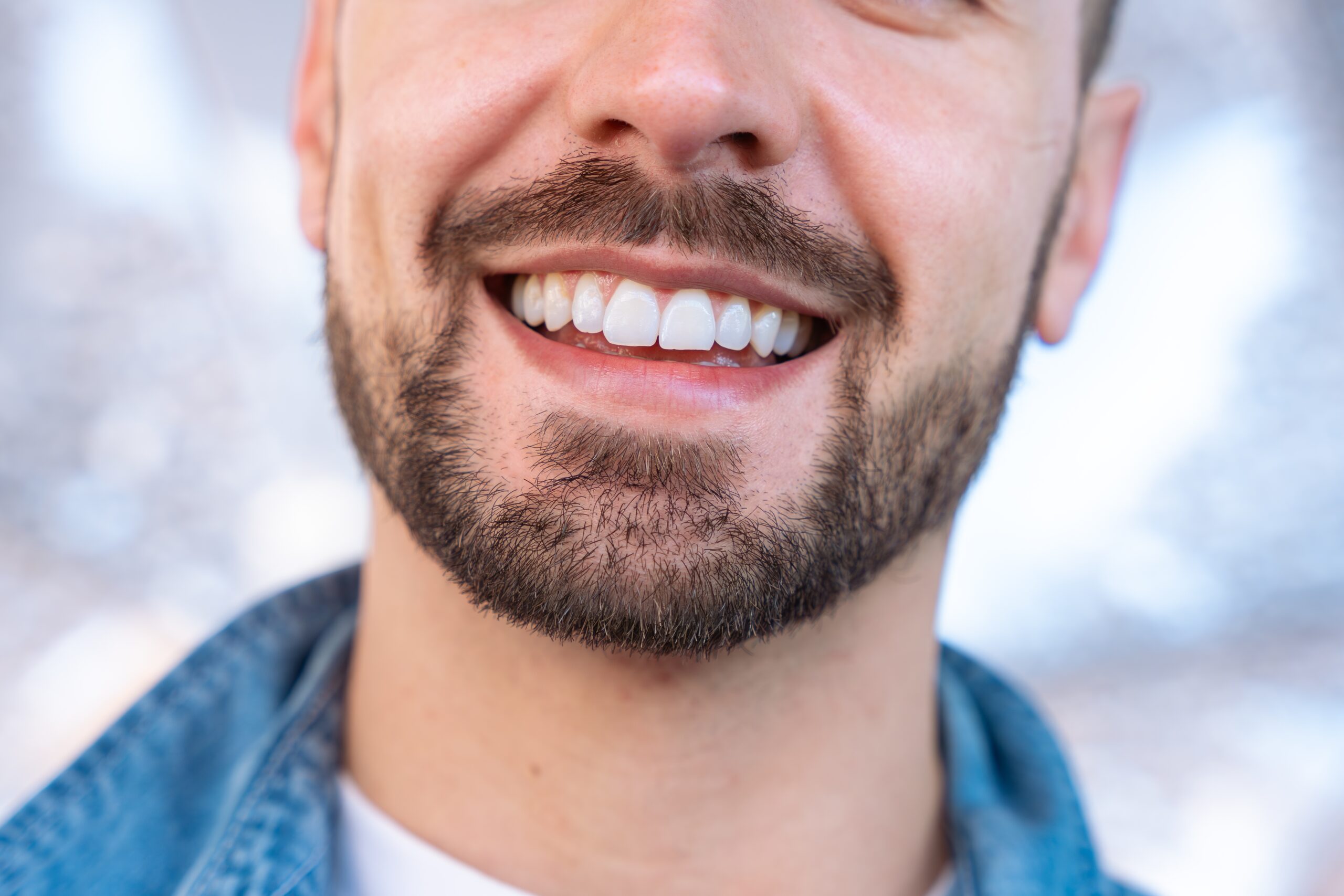 closeup of a young man with perfect white teeth