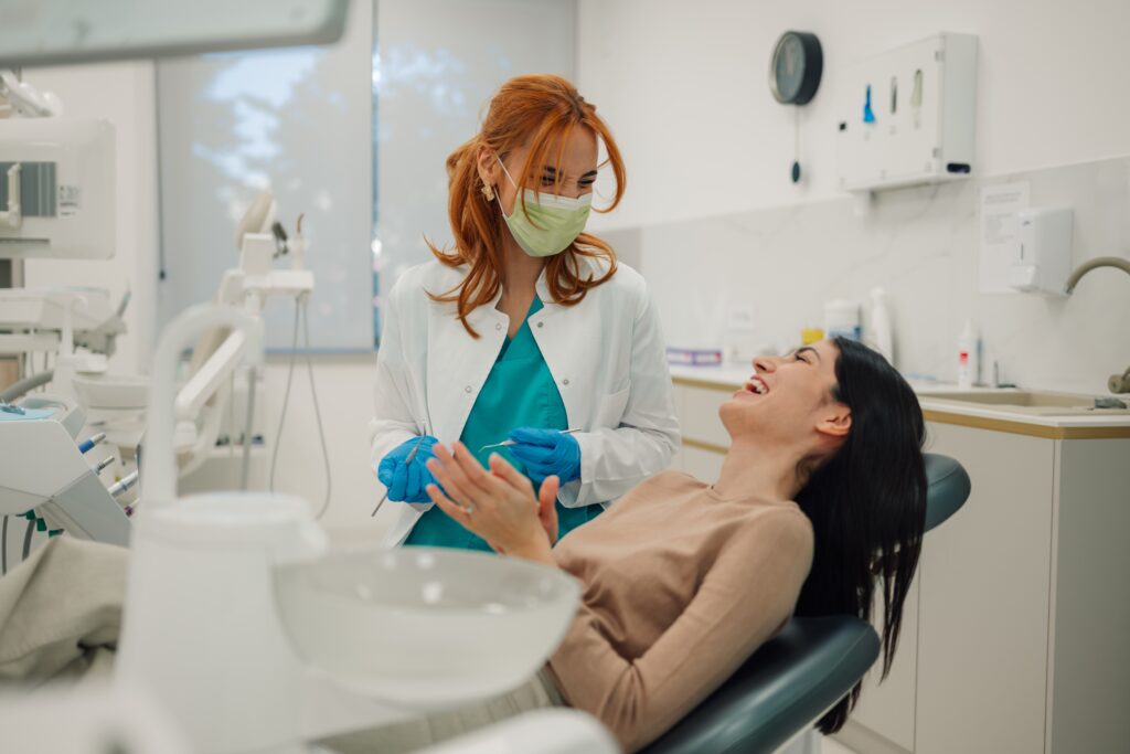 relaxed young woman laughing in a dental chair, dental sedation