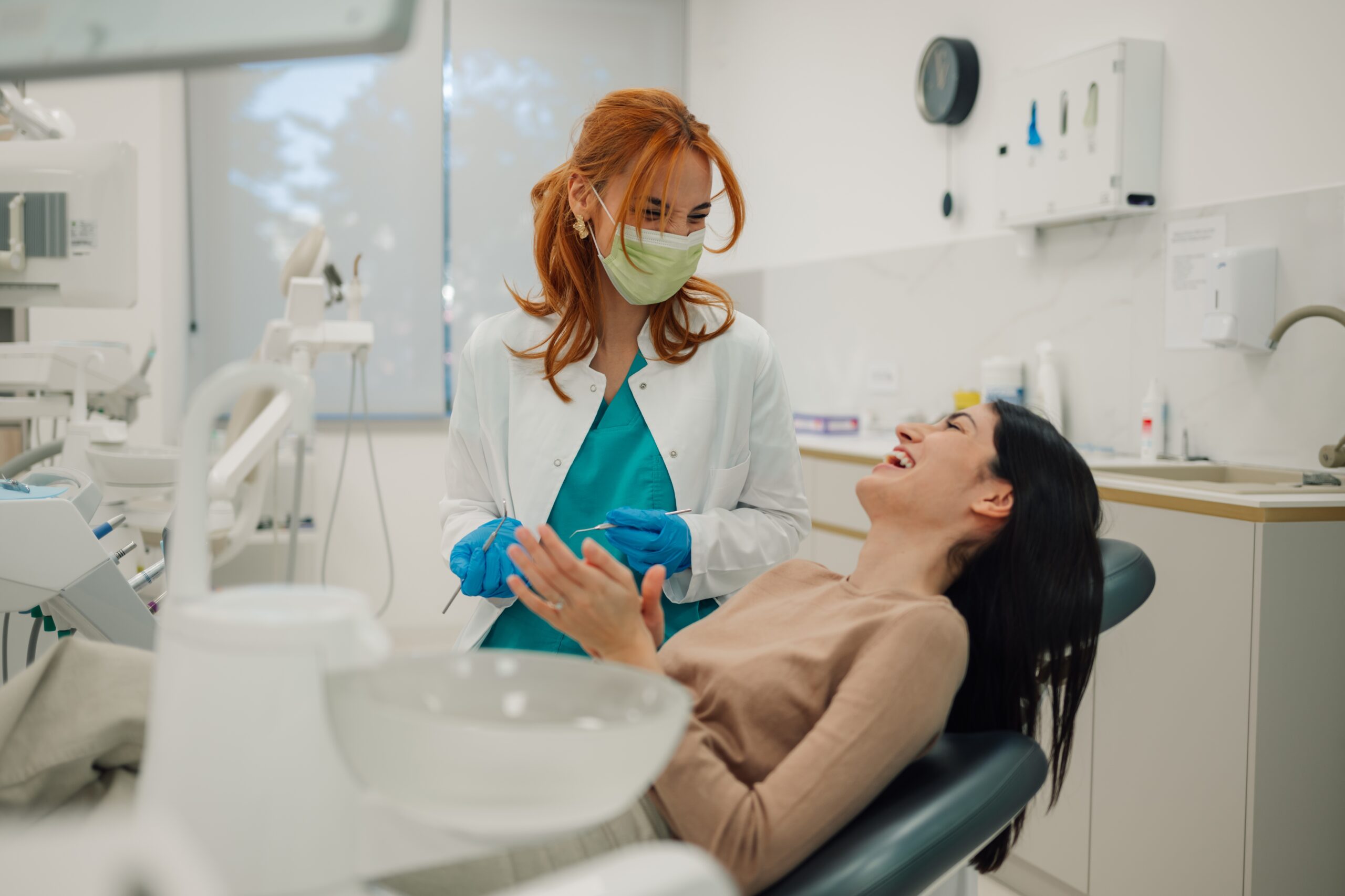 relaxed young woman laughing in a dental chair, dental sedation