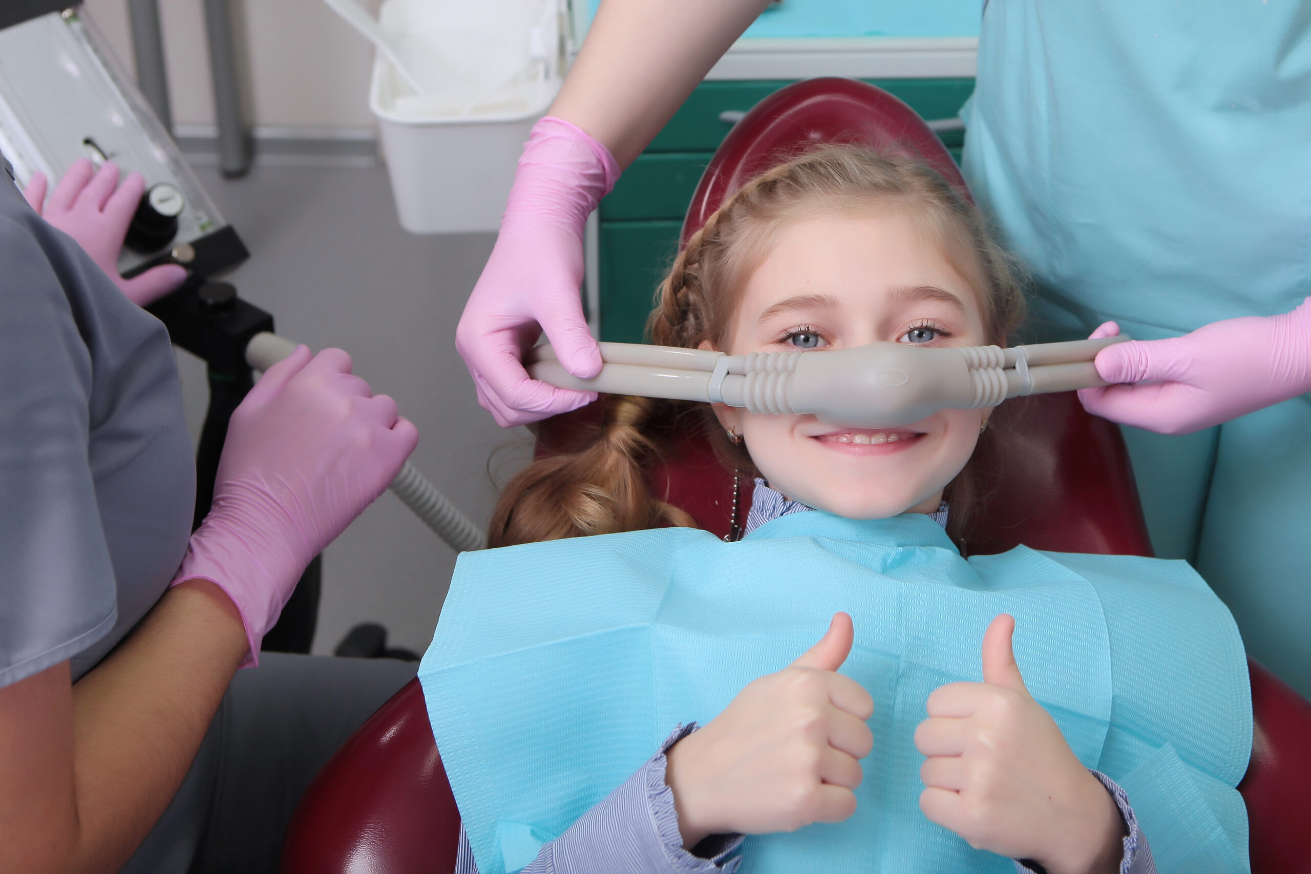 little girl giving the thumbs up, comfortable sedation
