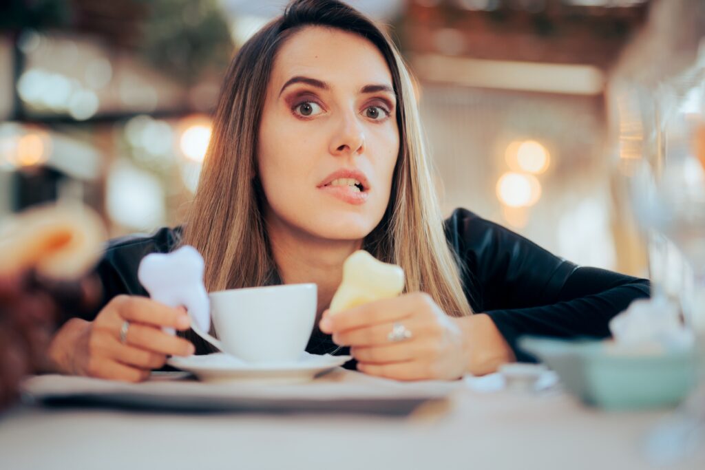 worried woman in a cafe, yellowing teeth