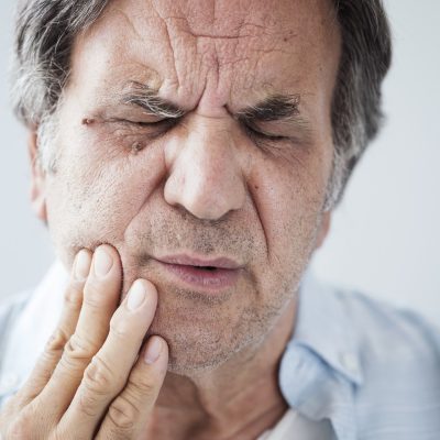 Clinton Township man with tooth infection in need of root canal from Shelby Township dentist