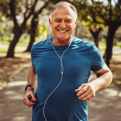 Portrait,Of,A,Senior,Man,In,Fitness,Wear,Running,In Man showing off his smile after restorative dental implants from dentist in Shelby Township, MI